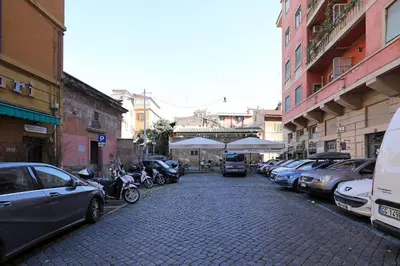 a cobblestone street with cars parked on the street at Stella House in Rome