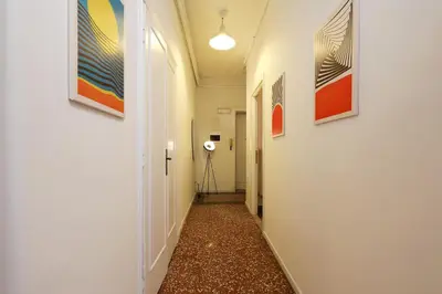 a hallway with paintings on the walls and a camera at Bologna GARDEN HOUSE in Rome