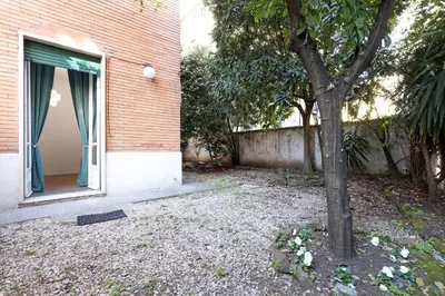 a tree in front of a building with a window at Bologna GARDEN HOUSE in Rome
