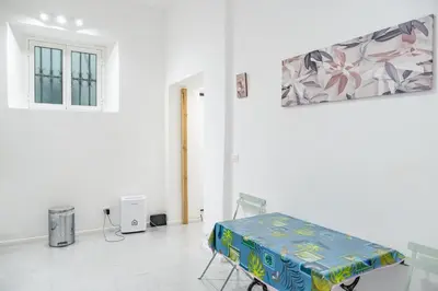 a room with a chair and a table with a box at Lion Renting Vatican Apartment in Rome