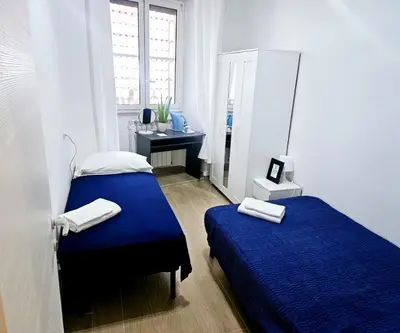 a small bedroom with two beds and a desk at BFabretti5 in Rome