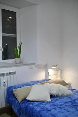 a bed with a blue blanket and a window at BFabretti5 in Rome