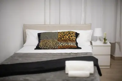 a bedroom with a bed with two leopard pillows at BFabretti5 in Rome