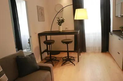 a living room with a table and a couch at Giulio Cesare Comfort Rooms in Rome