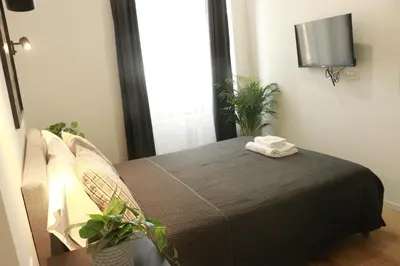 a bedroom with a bed with two towels on it at Giulio Cesare Comfort Rooms in Rome