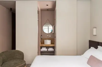 a bedroom with a bed and a mirror and two chairs at ATEL Relais in Rome