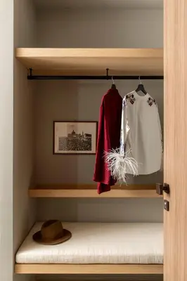a closet with a shelf with clothes and a hat at ATEL Relais in Rome