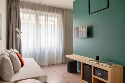 a living room with a couch and a window at ATEL Relais in Rome
