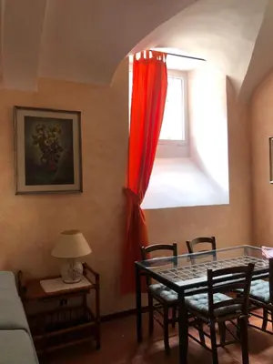 a dining room with a table and a window at Luminosa e accogliente casa Centro Storico in Rome