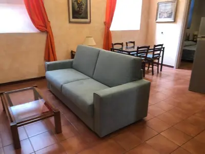 a living room with a couch and a table at Luminosa e accogliente casa Centro Storico in Rome