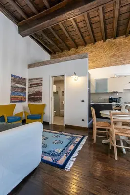 a living room with a white couch and a table at Exclusive House Ghetto in Rome