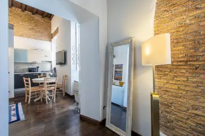 a room with a mirror and a dining room at Exclusive House Ghetto in Rome