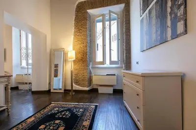 a living room with a dresser and a window at Exclusive House Ghetto in Rome