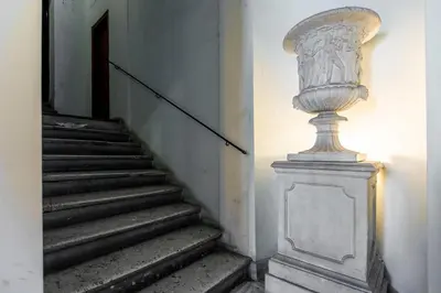 a staircase with a statue on the side of a building at Exclusive House Ghetto in Rome
