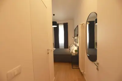a hallway with a mirror and a bed in a room at Giulio Cesare - Casa Palmeri in Rome