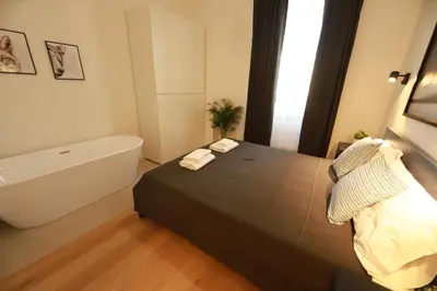 a bedroom with a bed and a bath tub at Giulio Cesare - Casa Palmeri in Rome