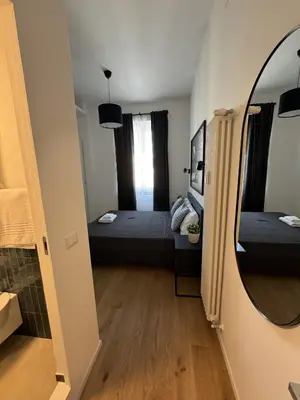 a small room with a bed and a mirror at Giulio Cesare - Casa Palmeri in Rome