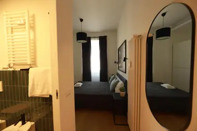 a small room with a bed and a mirror at Giulio Cesare - Casa Palmeri in Rome