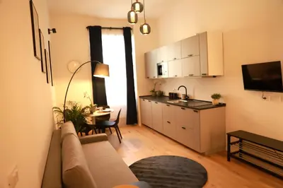 a living room with a couch and a kitchen at Giulio Cesare - Casa Palmeri in Rome