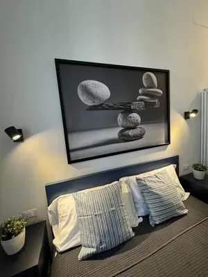 a room with a bed with a picture on the wall at Giulio Cesare - Casa Palmeri in Rome