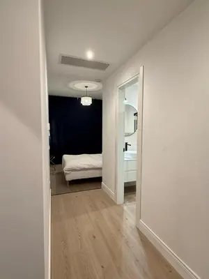 a room with a hallway with a bed and a mirror at Vita Lux Vatican Suites in Rome