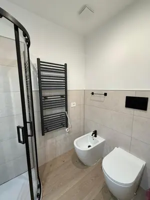 a bathroom with a toilet and a sink at Vita Lux Vatican Suites in Rome