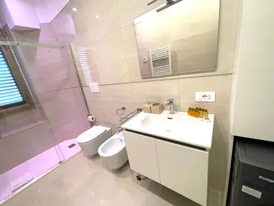 a bathroom with a sink and a toilet and a shower at Royal Golden House in Rome
