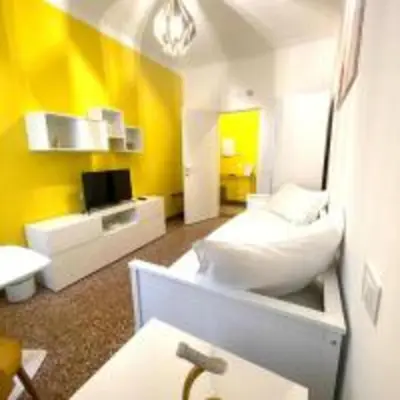 a living room with a yellow and white room at Royal Golden House in Rome