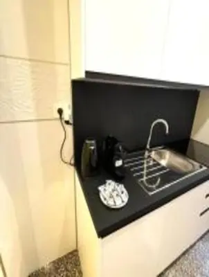 a kitchen with a black counter top with a sink at Royal Golden House in Rome
