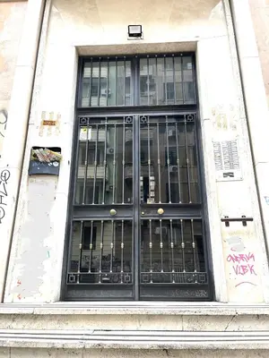 a door on a building with graffiti on it at Royal Golden House in Rome