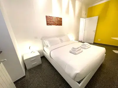 a bedroom with a white bed with towels on it at Royal Golden House in Rome