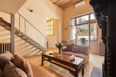a living room with a couch and a table at Casa Maestro, a Burghesius home in Rome