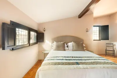 a bedroom with a bed and two windows at Casa Maestro, a Burghesius home in Rome