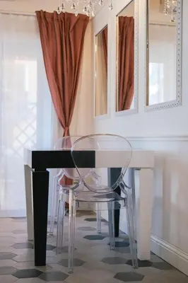 a dining room with a glass table and chairs at SuiteFrattini degli Eroi in Rome
