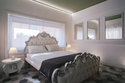 a bedroom with a large bed and a window at SuiteFrattini degli Eroi in Rome