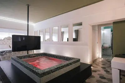 a room with a jacuzzi tub with a tv at SuiteFrattini degli Eroi in Rome