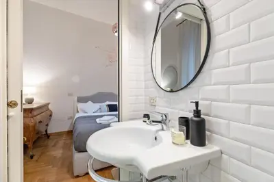 a bathroom with a white sink and a mirror at Kenzia Suite Aventino in Rome