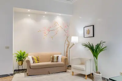 a living room with a couch and a chair at Kenzia Suite Aventino in Rome