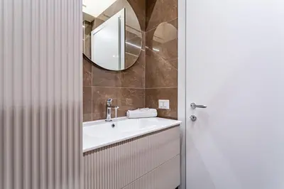 a bathroom with a sink and a mirror at iFlat Stylish & Cozy apt in the Heart of Monti in Rome