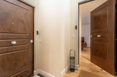 a hallway with a wooden door and a mirror at iFlat Stylish & Cozy apt in the Heart of Monti in Rome