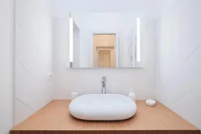 a bathroom with a white sink and a mirror at Castel Sant'Angelo - Elegant flat in Rome Centre in Rome