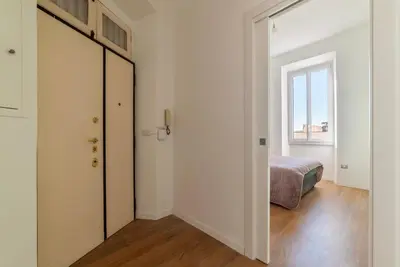 a bedroom with a door leading to a bed at GuestHost - Roma San Lorenzo Apartment in Rome