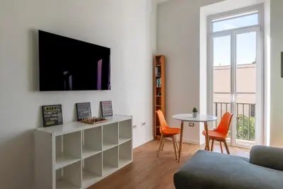 a living room with a tv and a table at GuestHost - Roma San Lorenzo Apartment in Rome