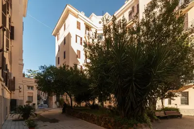 a street in a city with buildings and trees at GuestHost - Roma San Lorenzo Apartment in Rome