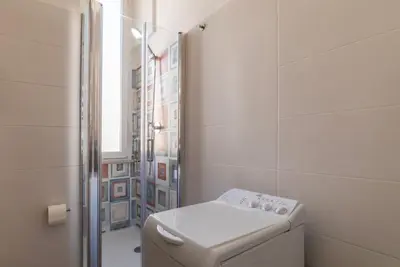 a white bathroom with a toilet and a shower at GuestHost - Roma San Lorenzo Apartment in Rome