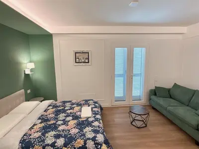 a bedroom with a bed and a couch at Villa Angela in Rome