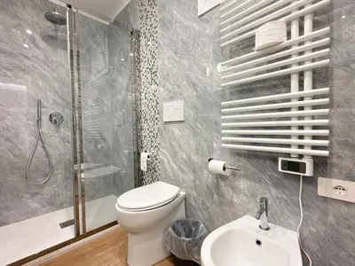 a bathroom with a toilet and a shower and a sink at Villa Angela in Rome