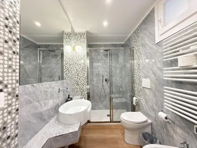a bathroom with a shower and a toilet and a sink at Villa Angela in Rome