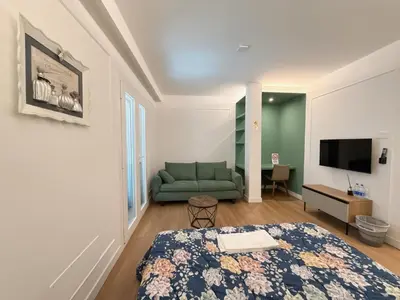 a room with a bed and a couch and a television at Villa Angela in Rome
