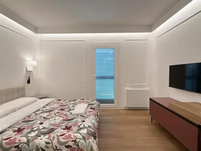 a bedroom with a bed and a flat screen tv at Villa Angela in Rome